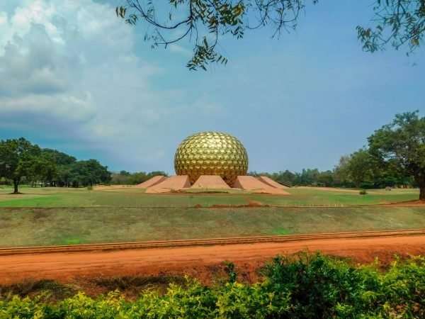 Auroville thrives as an international community practicing regenerative living, clean energy, and self-sufficiency.